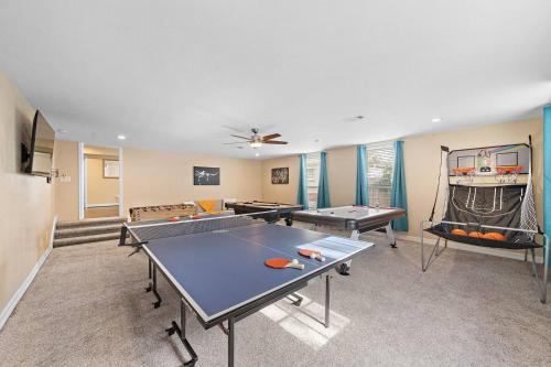 a living room with a ping pong table and ping pong balls at Nr DT, Med Center, Midtown Sleeps 16 Game Room in Houston