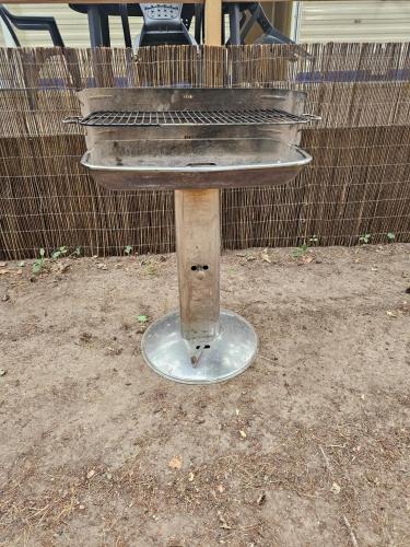 a concrete bird bath sitting in the dirt at Le calme in Braize