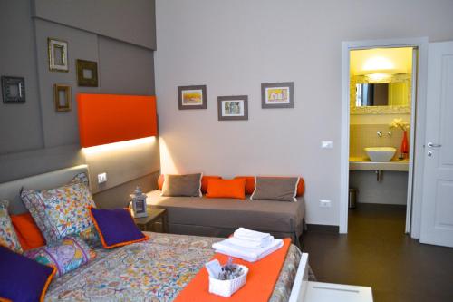 a living room with a couch and a bed at Gran Cancelliere B&B in Palermo