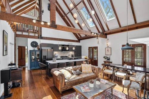 a living room with a couch and a table at Highgate - Cover Featured on Highlife Magazine! in Bowral