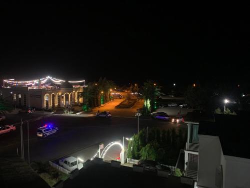 a night view of a building with a parking lot at Astara Guest House Marina in Astara