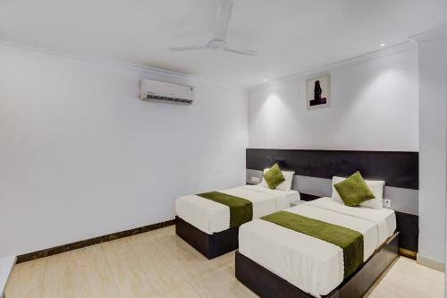 a bedroom with two beds and a couch at The Grace in Gurgaon