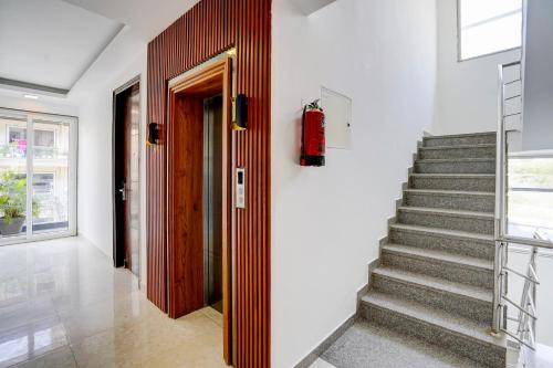 a staircase in a house with a red fire extinguisher at The Grace in Gurgaon