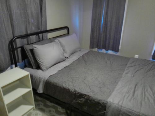 a small bedroom with a bed with white pillows at King Bed Creekfront Retreat in Jacksonville in Jacksonville