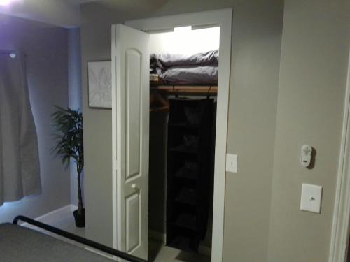 a room with a door leading to a closet with a bed at King Bed Creekfront Retreat in Jacksonville in Jacksonville