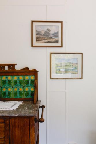 a room with two pictures on the wall and a table at The Farmhouse, elegance in the Margaret River coastal countryside in Rosa Brook