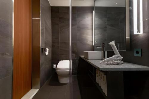a bathroom with a white toilet and a sink at Top Cloud Hotel Iksan in Iksan