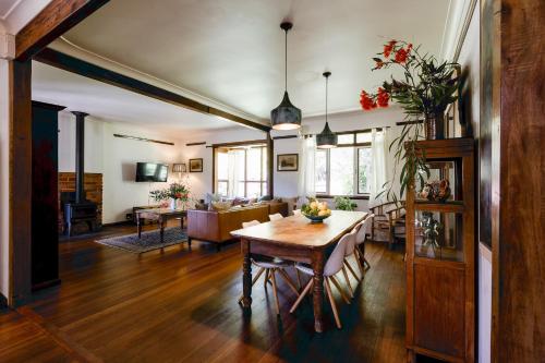 a living room with a table and a couch at The Farmhouse, elegance in the Margaret River coastal countryside in Rosa Brook