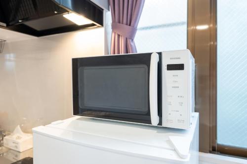 Una televisión o centro de entretenimiento en 立川ミモザハウス
