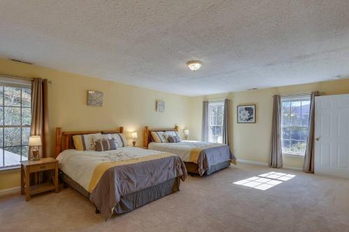 a bedroom with two beds and two windows at Close To Dt Asheville, Hot Tub, Pool Table in Weaverville