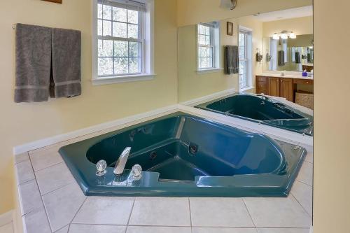 a large blue tub in a bathroom with a sink at Close To Dt Asheville, Hot Tub, Pool Table in Weaverville