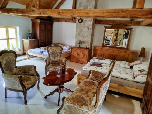 a bedroom with a bed and a table and chairs at Jílová tvrz in Rožmberk nad Vltavou
