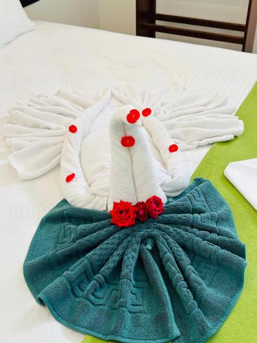 a pair of white gloves and a blue dress on a bed at Jaffna City Palace Hotel in Jaffna