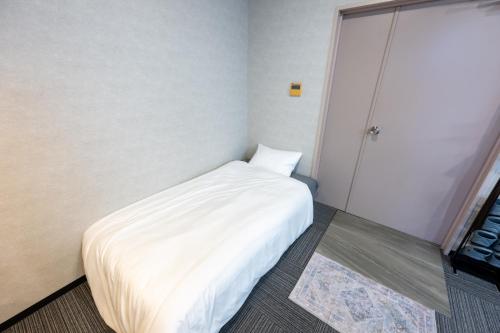 Una cama o camas en una habitación de 立川ミモザハウス
