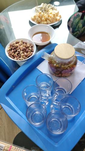 a blue tray with bowls and other food on a table at Bluci seksti in Seksti