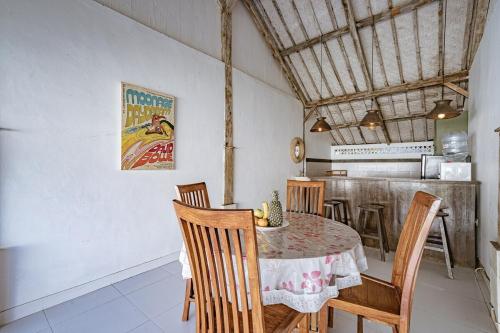 a dining room with a table and chairs at Villa La Luna 2BR Joglo Style with Pool by Damaresa in Dalung