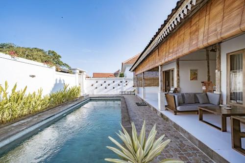 a swimming pool in the backyard of a house at Villa La Luna 2BR Joglo Style with Pool by Damaresa in Dalung