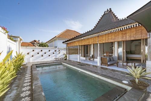 a swimming pool in the backyard of a house at Villa La Luna 2BR Joglo Style with Pool by Damaresa in Dalung