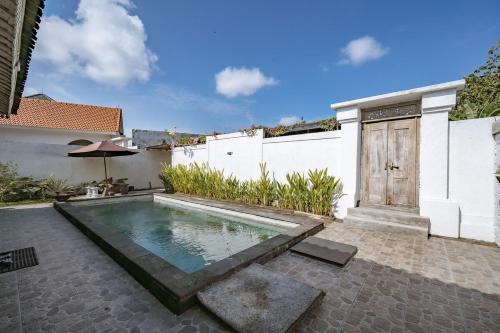 a swimming pool in the backyard of a house at Villa La Luna 2BR Joglo Style with Pool by Damaresa in Dalung