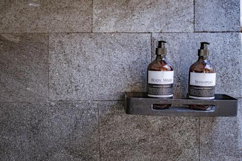 two bottles of wine sitting on a shelf on a wall at Villa La Luna 2BR Joglo Style with Pool by Damaresa in Dalung