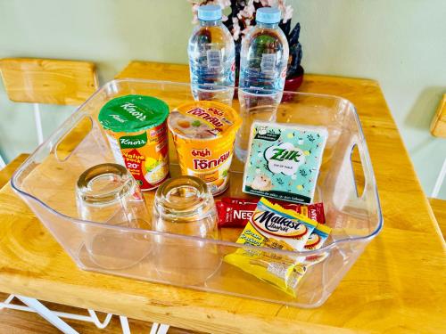 a plastic container filled with food and drinks on a table at นกฮูกเฮ้าส์ ริมโขง in Nong Khai
