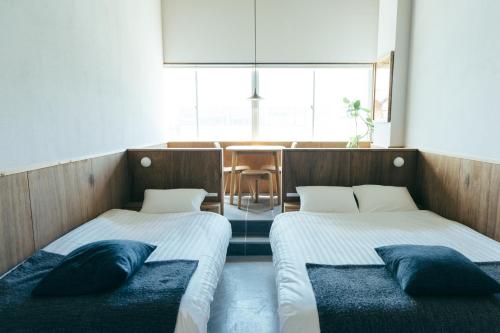 Postel nebo postele na pokoji v ubytování ROI SPACE Kagoshima