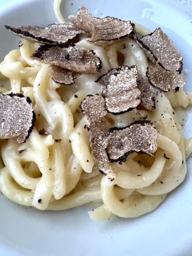 a plate of pasta with seasoning on top of it at Agriturismo La Colmata in Cesa