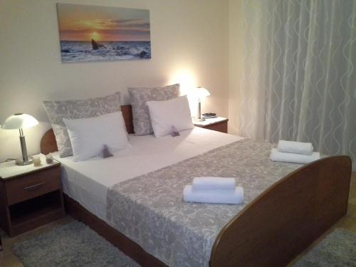 a bedroom with a large bed with two pillows on it at Holiday Home Villa Romantica in Sveti Filip i Jakov