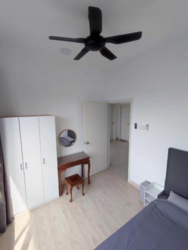 a living room with a ceiling fan and a couch at Comfy Room in High Floor! in Kuala Lumpur