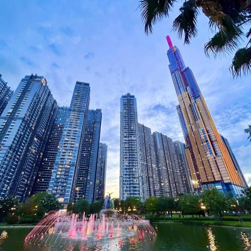 a fountain in front of a city with tall buildings at The Peak Suite at Landmark Plus in Ho Chi Minh City