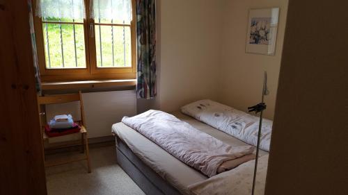 a room with two beds and a window at Ferienwohnung Gadenstatt in Davos