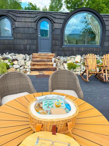 a patio with a table with a hot tub on it at Friday Inn Igloo - Intimitate, Jacuzzi, Natura, Priveliste & Iaz - Escapadă romantică premium la o oră de Bucuresti - Eco Friendly Micro-Resort in Comarnic