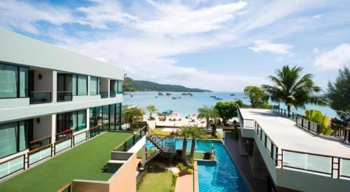 an apartment building with a view of the water at Phi Phi Nice Beach Hotel Hip in Phi Phi Don