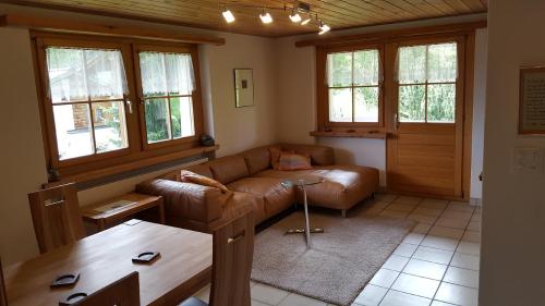 a living room with a couch and a table at Ferienwohnung Gadenstatt in Davos