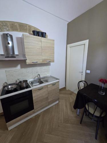 a small kitchen with a sink and a stove at Ancaranvs B&B in Bitonto