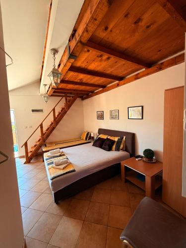 a bedroom with a bed and a wooden ceiling at Apartments Lav Costas in Herceg-Novi
