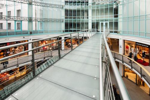 a view of a shopping mall from the top of the escalator at Pentahotel Rostock in Rostock