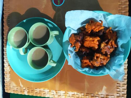 two plates of food and two cups of coffee at Kanchan Kunja Homestay in Rishop