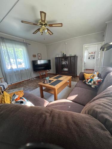 a living room with a couch and a table at Vita villan in Haparanda