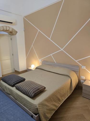 a bedroom with a large bed with a wall at Ancaranvs B&B in Bitonto