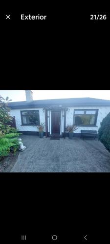a picture of a house with a bench in a yard at 0ne bed house on private road in Lusk