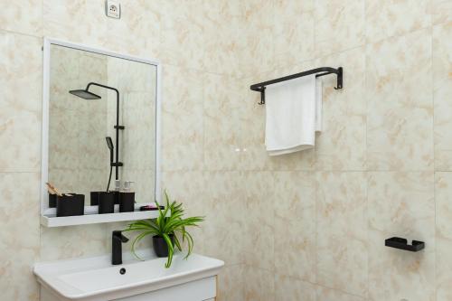 a bathroom with a sink and a mirror at kigali Pillar House inn in Kigali