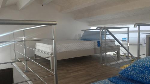 a room with two bunk beds and a ladder at Campeggio Praia Mare in Campofelice di Roccella