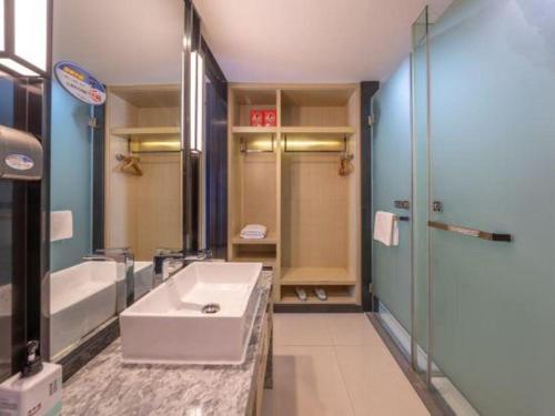a bathroom with a sink and a shower at Echarm Hotel Taizhou International Convention and Exhibition Center 