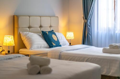 a hotel room with two beds and two lamps at Sea Sunset Hotel Phu Quoc - Welcome to a mixing world of friends in Phu Quoc