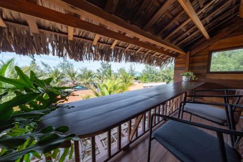 a balcony with a view of the ocean at Hoianbang Beach Front Villa and Restaurant in An Bang
