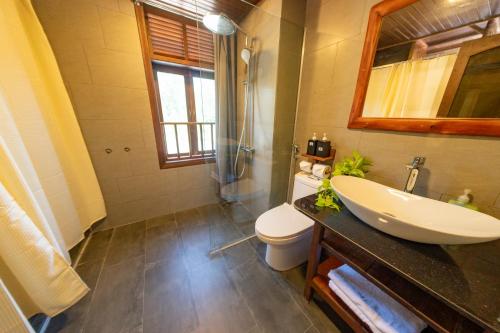 a bathroom with a sink and a toilet and a shower at Hoianbang Beach Front Villa and Restaurant in An Bang