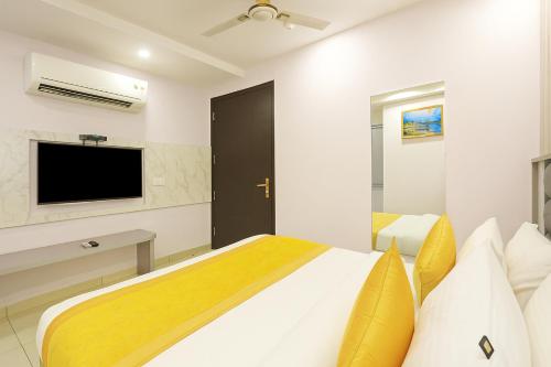 a bedroom with a bed and a flat screen tv at Hotel Mayfair Just a Minute Away From New Delhi Railway Station and Connaught place in New Delhi