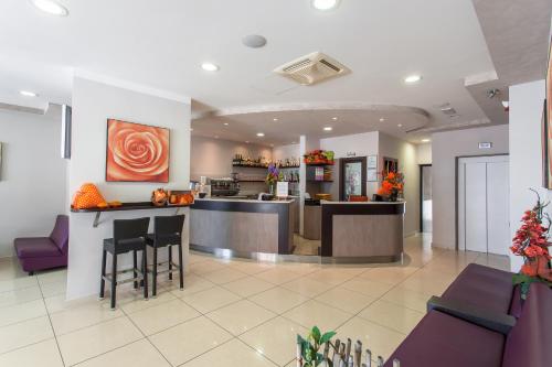 a lobby of a hotel with a bar and chairs at Hotel Giove dipendenza Hotel Fiamma in Cesenatico