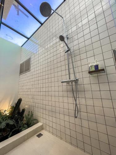 a bathroom with a shower with white tiled walls at The X10 Nordic Tent and Glamping Pool Villa Khaoyai เขาใหญ่ - SHA Certified in Ban Thung Sawang